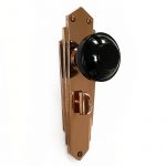 black knobs on copper deco plate