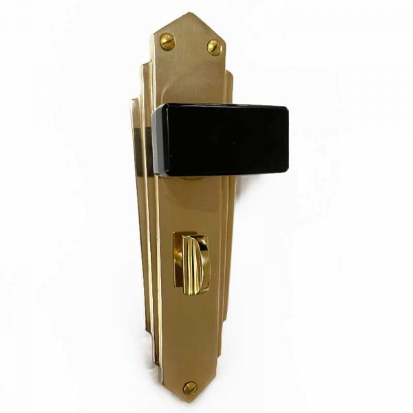 Black door knobs on Brass Deco Plates